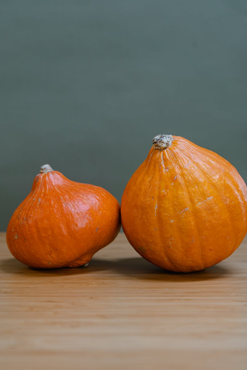 orange pumpkin on brown wooden table
